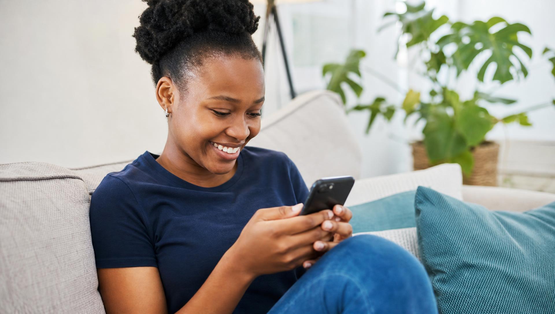 Smiling learner using her phone to study